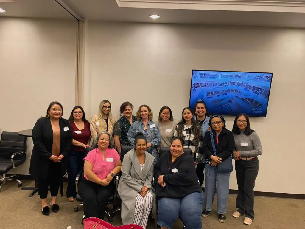 A large group of women posing together at a discipleship workshop