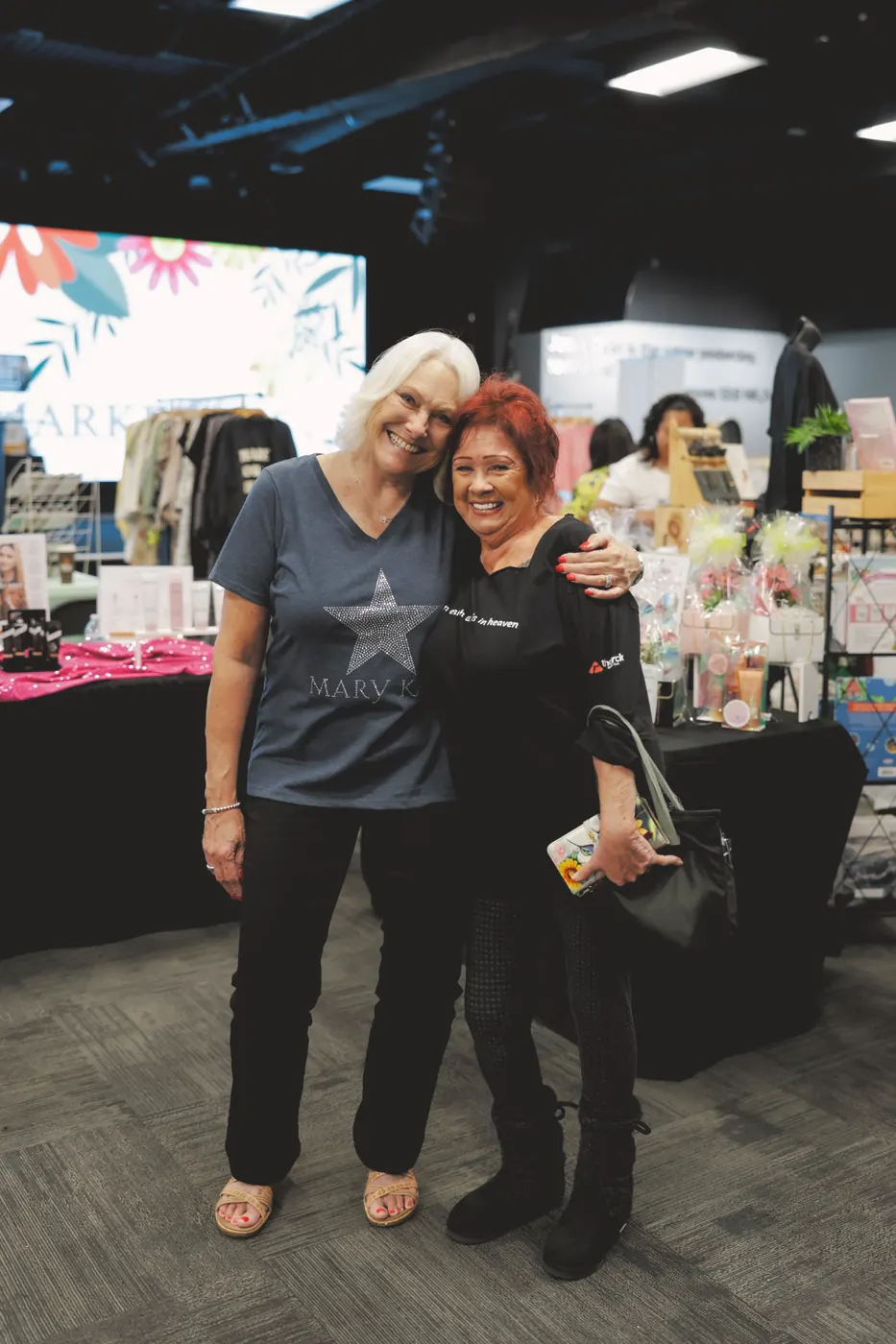 Two women smiling together at the Spring market